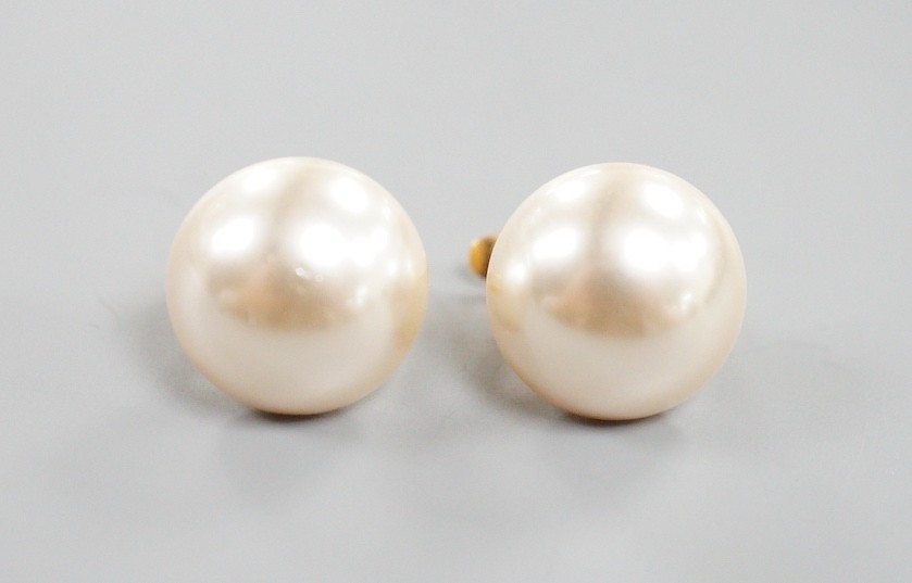 A modern pair of 18k yellow metal and mabe pearl earrings, diameter 13mm, gross weight 5 grams.